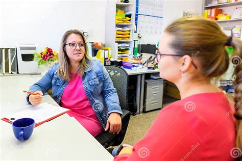 Therapist Talking To a Young Mother after Assessing Her Daughter in ...