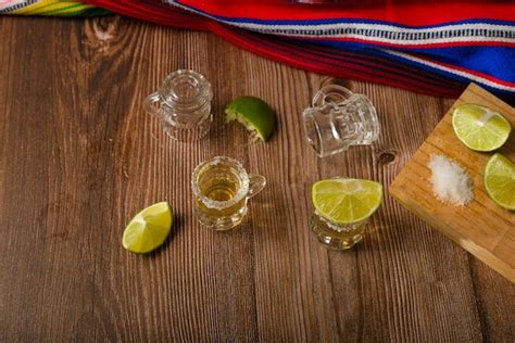 Premium Photo Tequila Shots With Salt And Lime On A Bar Table Shots