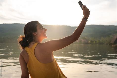 Travel Woman Taking A Selfie At Sunset By Stocksy Contributor Luis