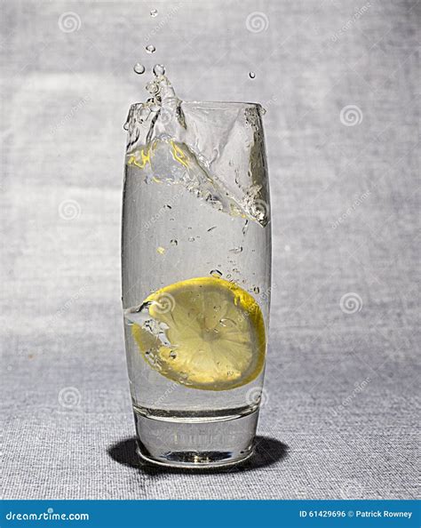 Slice Of Lemon Dropped In Glass Of Water Stock Photo Image Of Dropped