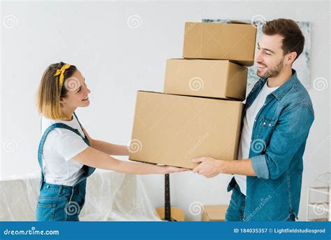 Couple Holding Cardboard Boxes And Looking At Each Other Stock Image