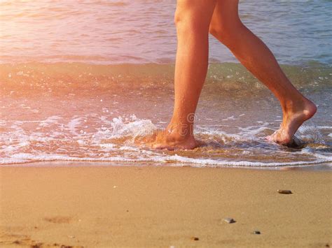 Man Walking Barefoot on Beach by Water Edge Stock Photo - Image of ...