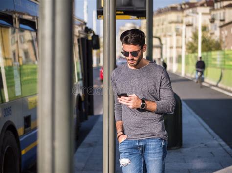 Man Using Phone At Bus Stop Stock Image Image Of Gadget Internet