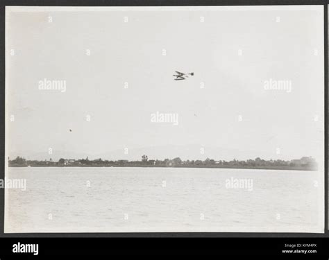 photograph   curtiss pusher biplane flying  san diego bay representing early aviation