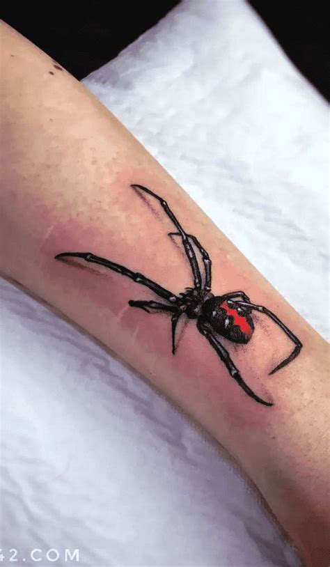 A Black And Red Spider Tattoo On The Arm