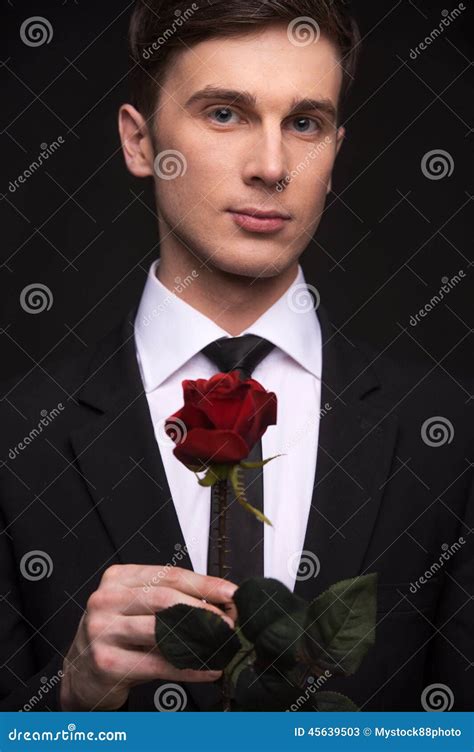 Young Attractive Man In Suit Holding Red Rose Stock Image Image Of