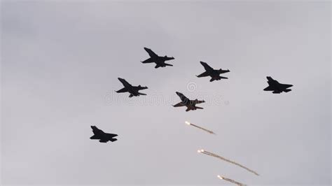 Fighter Jet Aircrafts In Flight In Formation With One That Releases