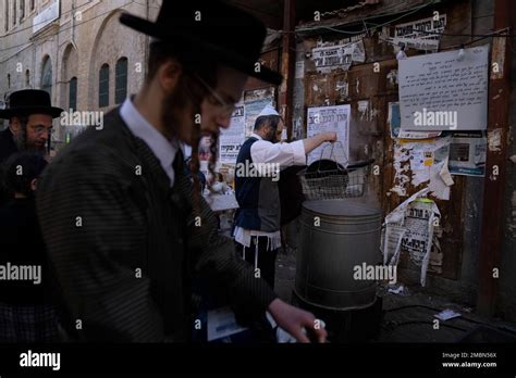 An Ultra Orthodox Jewish Man Dips Cooking Utensils In Boiling Water To