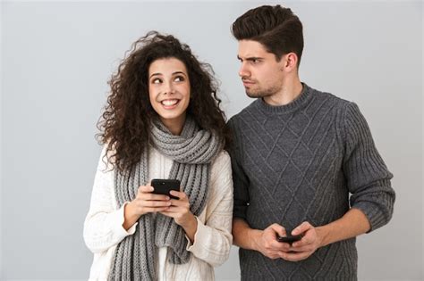 Premium Photo Couple Wearing Sweaters Standing Isolated Over Gray