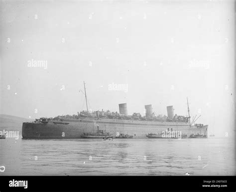 FORMER LUXURY LINER, NOW TROOPSHIP, SS QUEEN MARY AT A BRITISH PORT. 21 ...