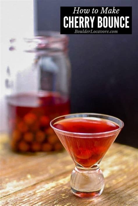 A Glass Filled With Liquid Sitting On Top Of A Wooden Table