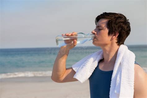 Man Drinking Water from Bottle at Beach Stock Image - Image of athletic, casual: 91797001