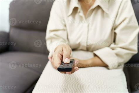 Elderly Woman Watching Smart Tv And Using Remote Controller Hand