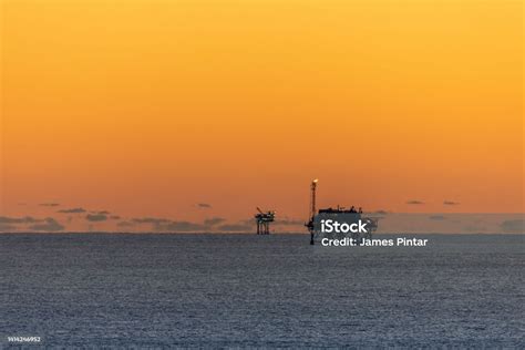 Offshore Drilling Platforms During Sunset In The Gulf Of Mexico Stock