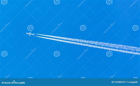 Two Engined Airplane During Flight In High Altitude With Condensation