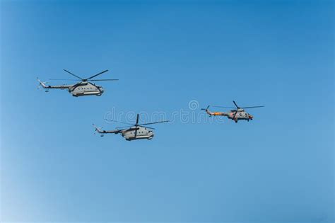 Three Helicopters Flying On A Clear Day At A Military Parade Rehearsal