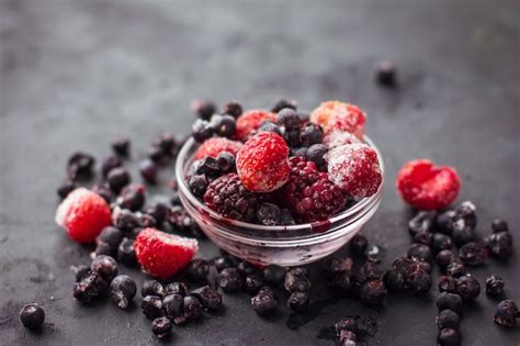 Cerca De Frutas Y Bayas Mezcladas Congeladas Sobre Una Mesa Negra