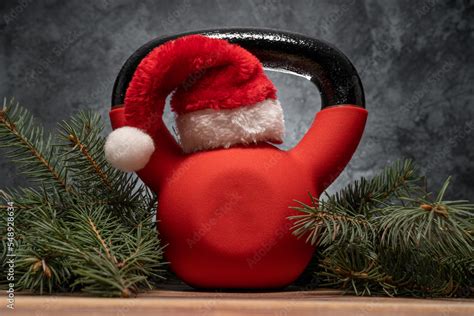 Heavy Kettlebell In Red Santa Claus Hat Exercise Equipment As