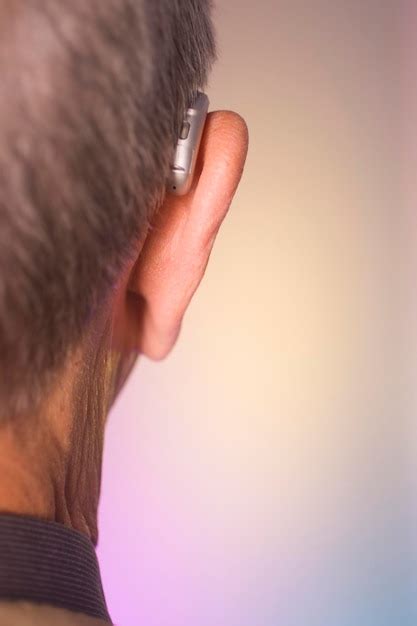 Premium Photo Rear View Of A Man Wearing Hearing Aid Against Colored