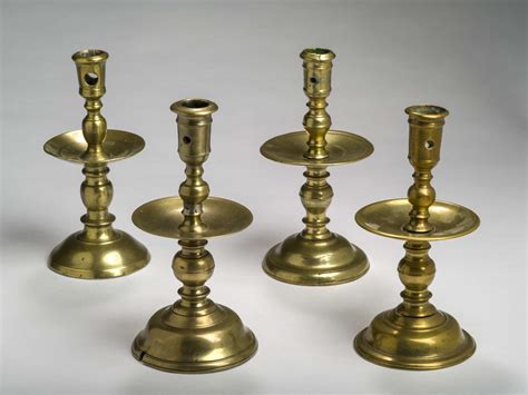 Four Dutch Brass ‘heemskerk’ Candlesticks One Probably Sixteenth Century Three Seventeenth