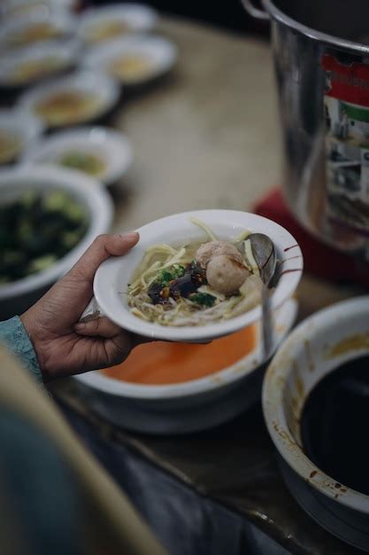 Premium Photo Midsection Of Person Having Food In Plate