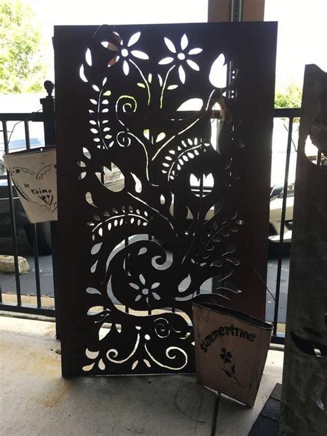 An Iron Gate With Flowers And Vines On It