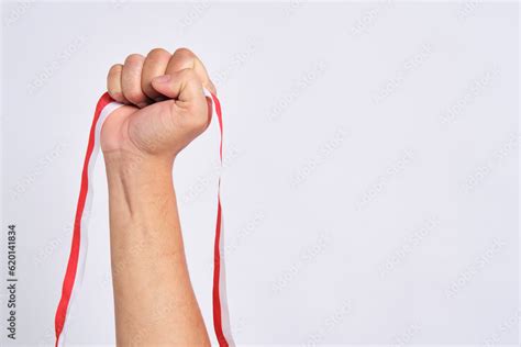 Human Hand Holding A Red And White Ribbon As A Symbol Of The Indonesian