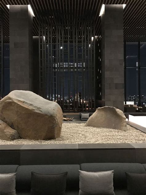 A Large Rock Sitting In The Middle Of A Living Room Filled With Lots Of