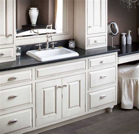 Semi Custom Bathroom Cabinets With White Color And Black Countertop