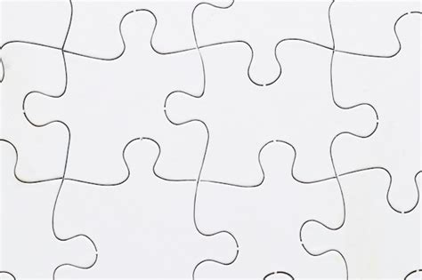 Free Photo Close Up Of White Jigsaw Puzzle Grid Background