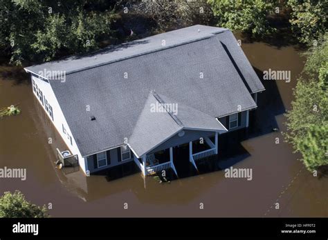 Aerial View Of A House Submerged In Flood Water After A Hurricane Hit