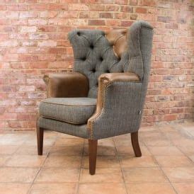 A Gray Chair Sitting In Front Of A Brick Wall