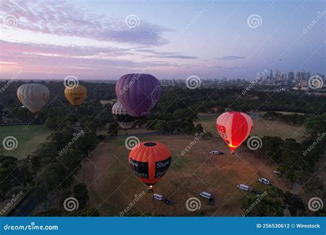 Group Of Hot Air Balloons Taking Off With The Glow Of The Fire At Sunset Editorial Photography
