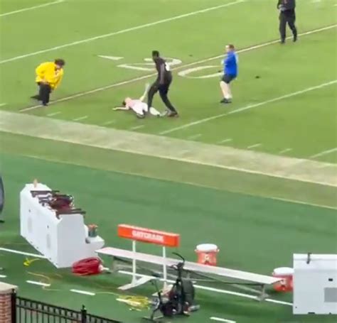 Fan Knocked Out Cold By Ncaa Security Dragged Off Field