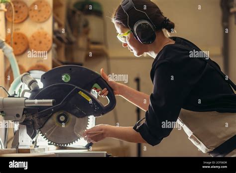 Carpenter Using Circular Saw For Cutting Wooden Boards Construction