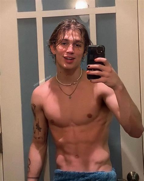 A Shirtless Man Taking A Selfie In Front Of A Mirror With His Cell Phone