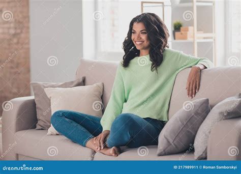 Portrait Of Attractive Cheerful Girl Sitting On Divan Staying Home