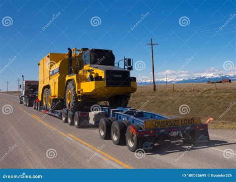 Oversized Equipment Being Pulled On A Trailer Editorial Stock Photo