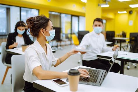 Office Worker Wearing Face Mask For Social Distancing For Virus