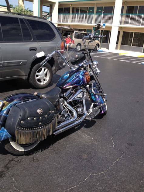 a motorcycle parked in a parking lot next to a car