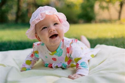 baby girl  smile  laying  garden   lawn happy baby stock