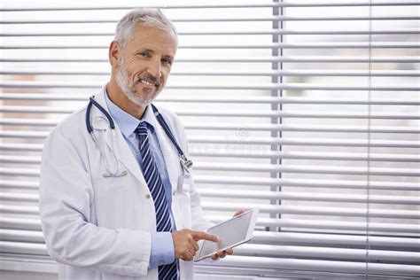 Using Tech To His Advantage In His Medical Practice Portrait Of A Mature Male Doctor Using A