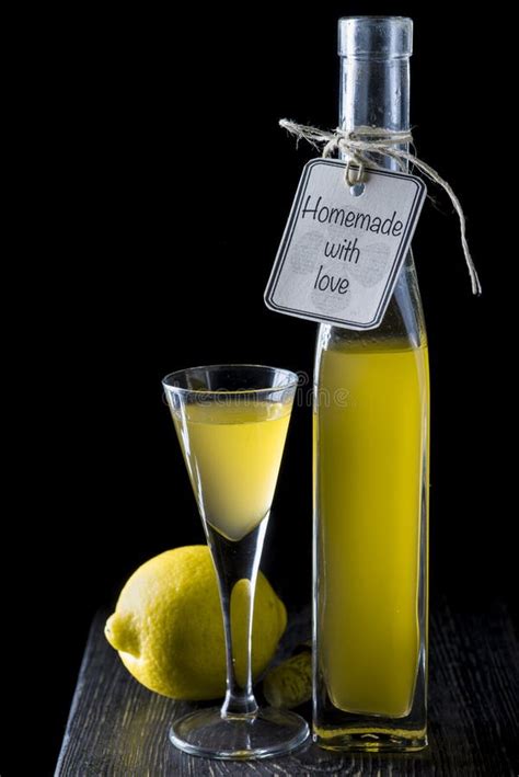 Italian Limoncello In A Shot Glass On A Black Wooden Background Stock