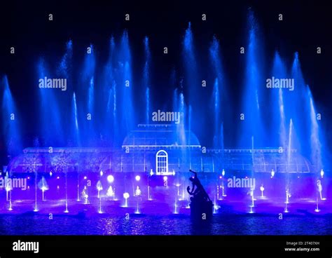 LONDON, UK - January 04, 2023. Christmas at Kew. Light show illuminates the fountain and Palm ...