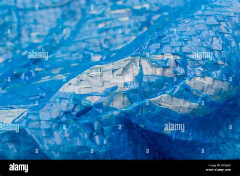 Macro Photo Of Very Worn Blue Cheap Poly Tarpaulin Exposed Inner