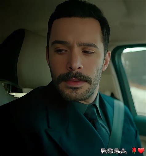 A Man Wearing A Suit And Tie Sitting In The Back Seat Of A Car With His