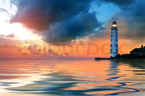 Beautiful Nightly Seascape With Lighthouse And Moody Sky At The Sunset