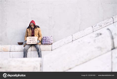 Homeless Beggar Man Sitting In City Holding Cardboard Sign Copy Space