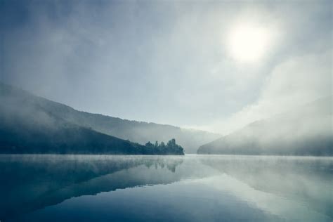 Premium Photo | Foggy sunrise on lake.