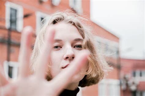 Kinky Blonde Girl Shoots Herself Smartphone Smiling On Pink Studio Background Stock Photo